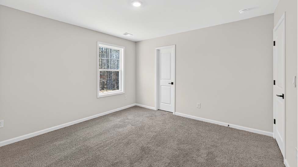 Carpeted bedroom with large window