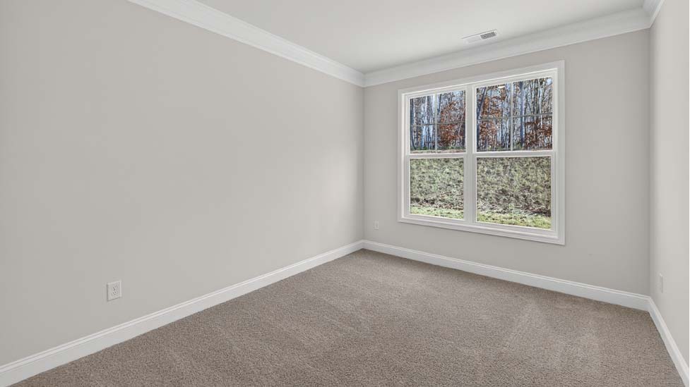 Carpeted bedroom with large window
