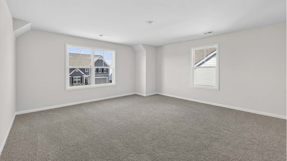 Carpeted bedroom with large window