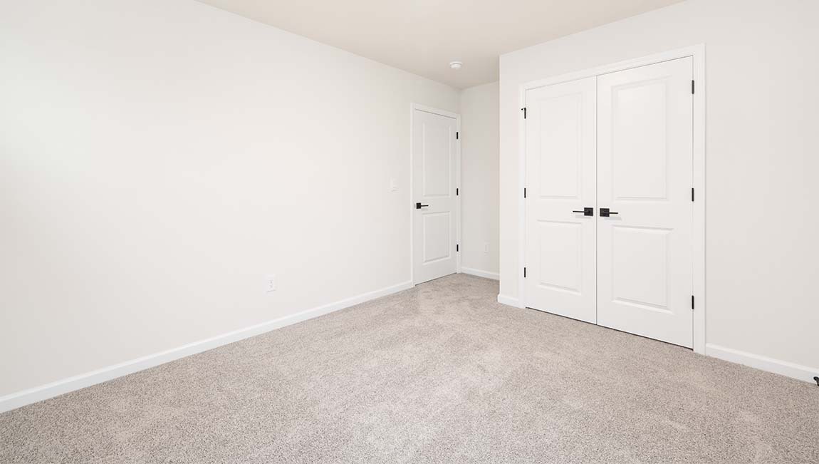 Carpeted bedroom with small window