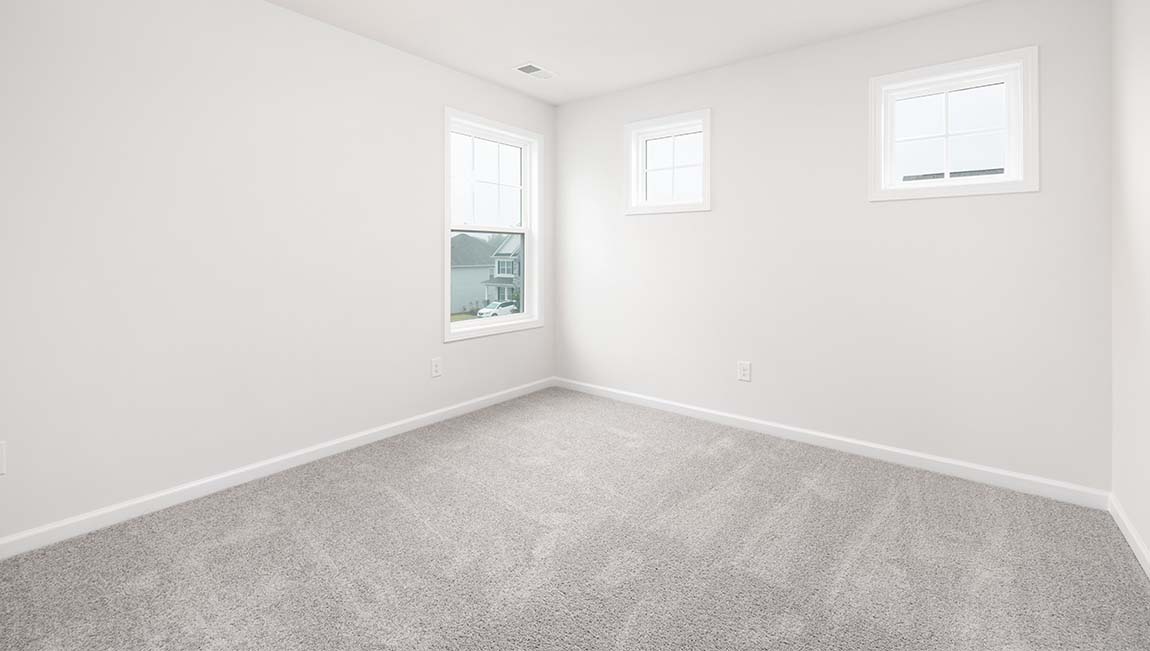 Carpeted bedroom with small window