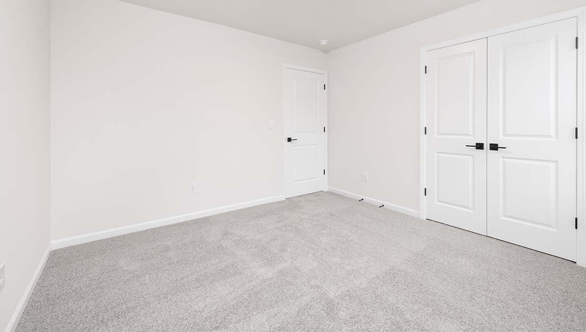 Carpeted bedroom with small window