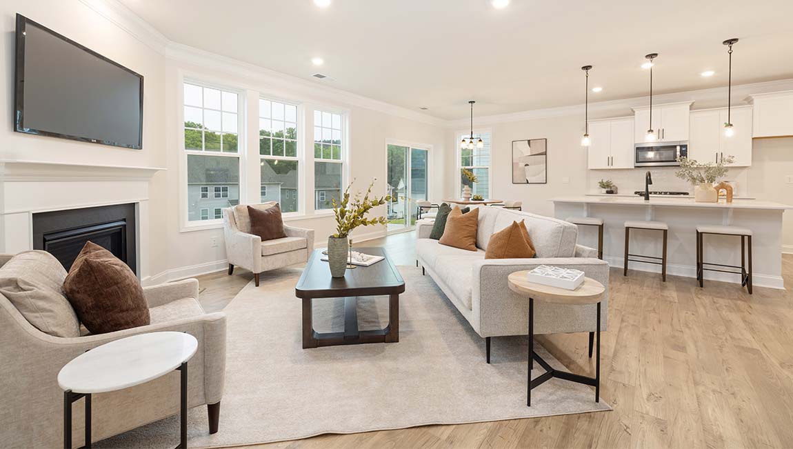 open concept living room with fireplace and view of kitchen, breakfast area and staircase