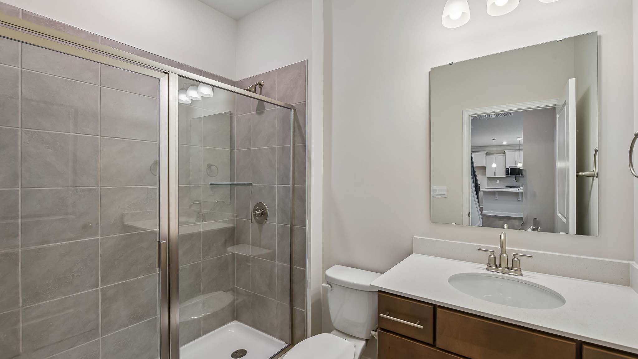 Bathroom with single sink and standing glass shower