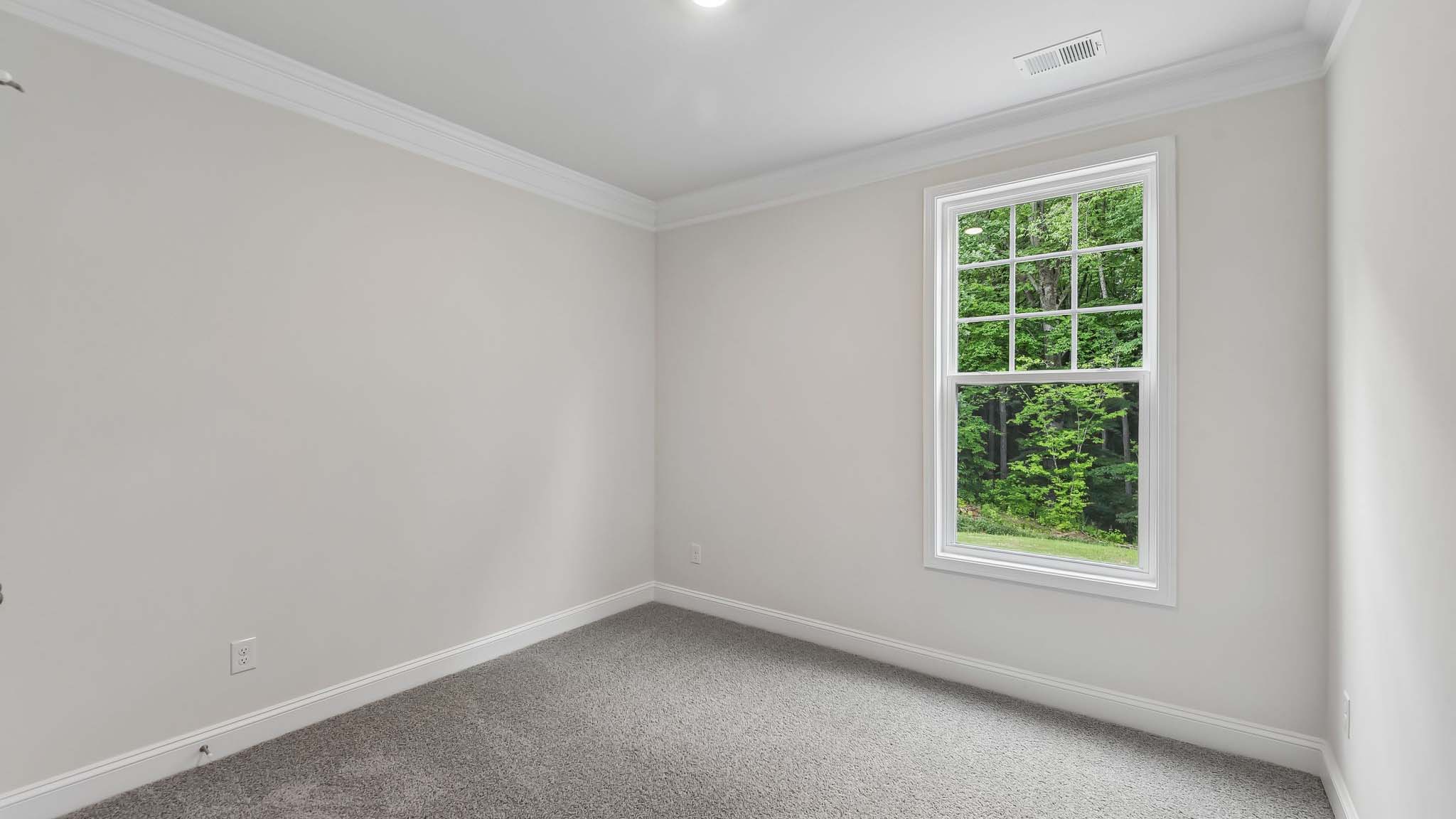 Carpeted bedroom with windows