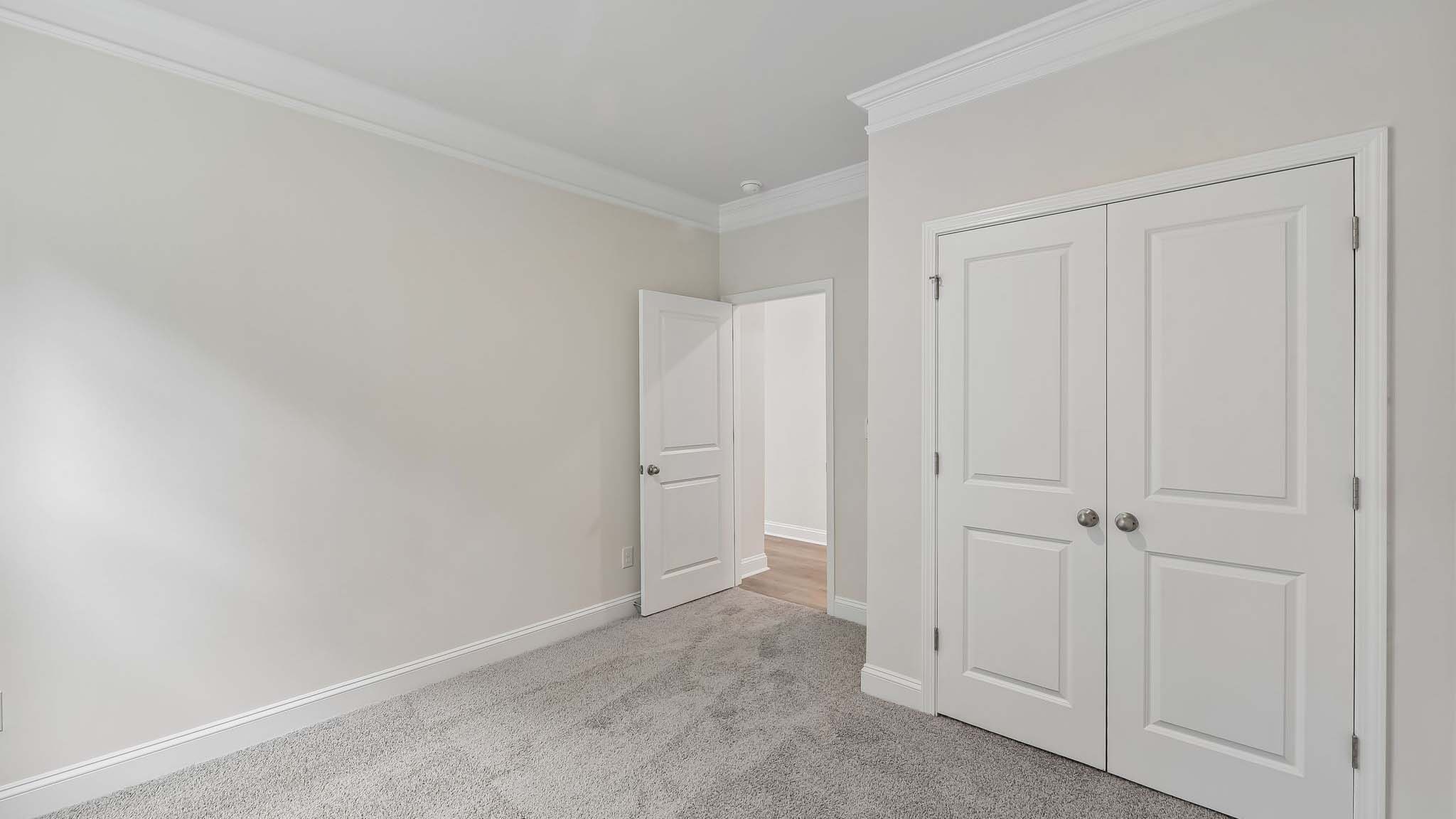 Carpeted bedroom with windows