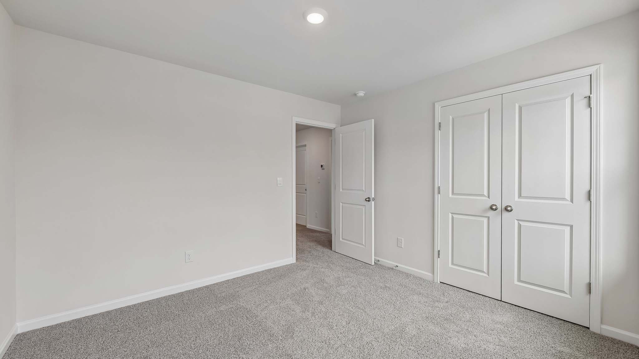 Carpeted bedroom with windows