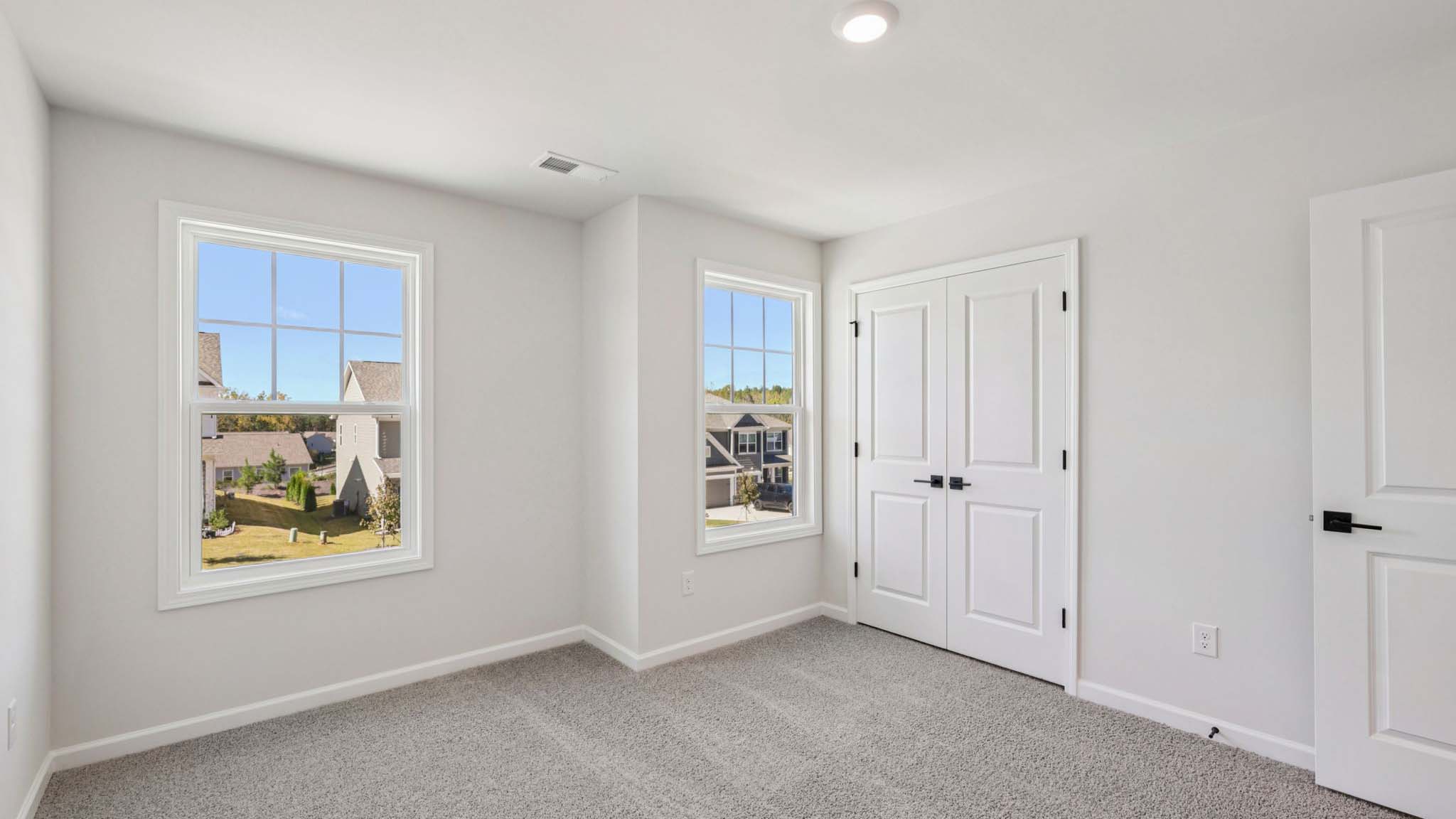 Carpeted bedroom with small window