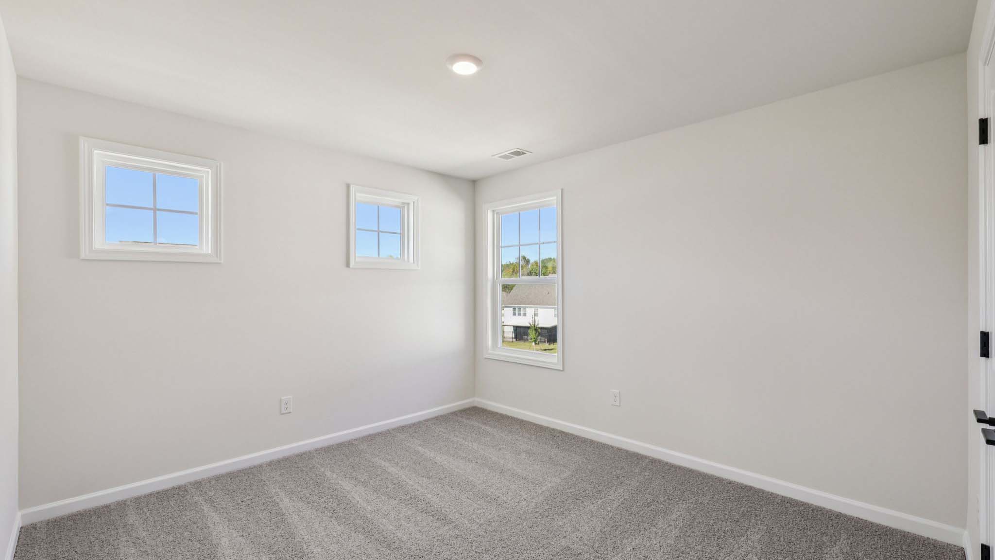 Carpeted bedroom with small window