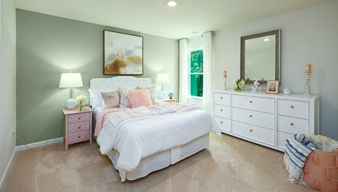 Adair Woods Winston model carpeted bedroom with a small window