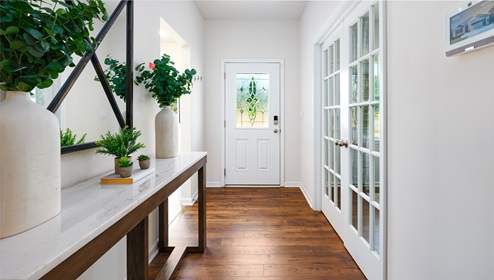 model welcoming foyer with wood floors