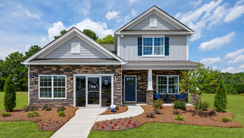 Adair Woods Winston Two-story model home with grey siding and stone and a two car garage