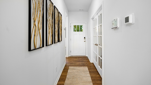 Welcoming foyer with vinyl floors, view of front door