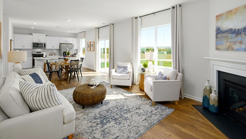 Open family room with fire place, vinyl floors, and large window