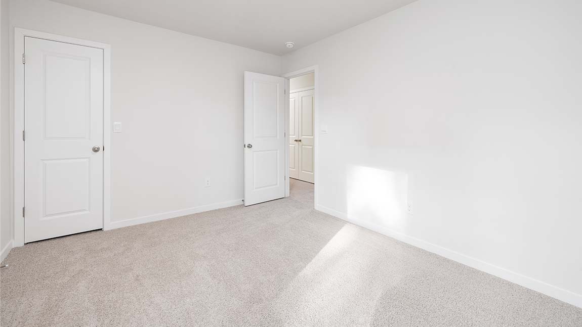 Carpeted bedroom with large window