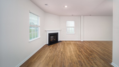 Family room with large windows and fireplace