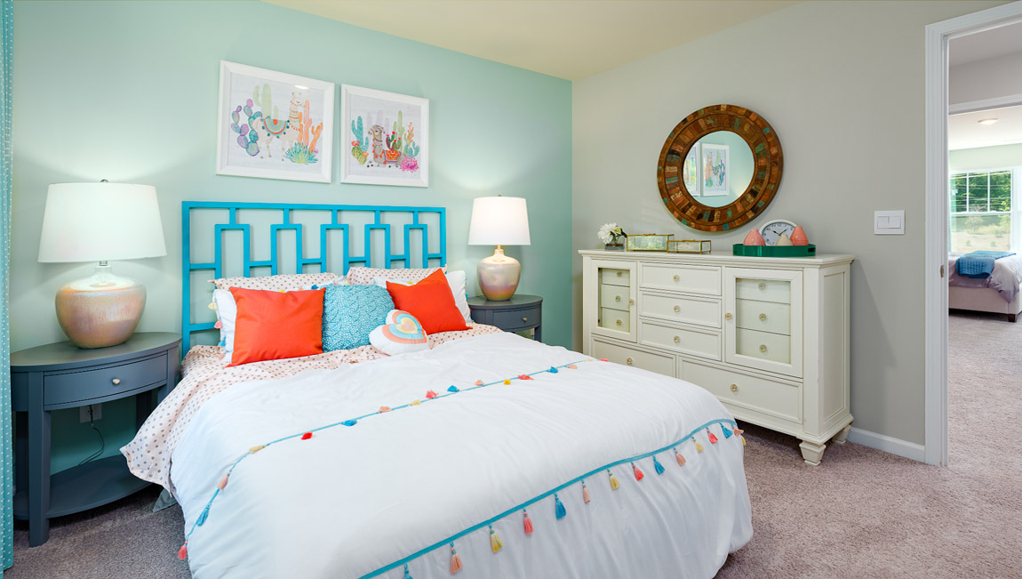 Model carpeted bedroom with small window