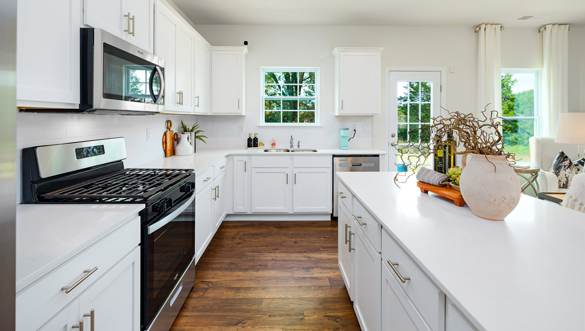 Kitchen and island with white counters and cabinets