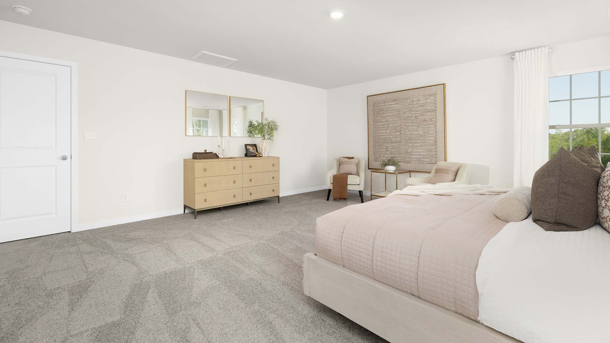 Primary carpeted bedroom with large windows