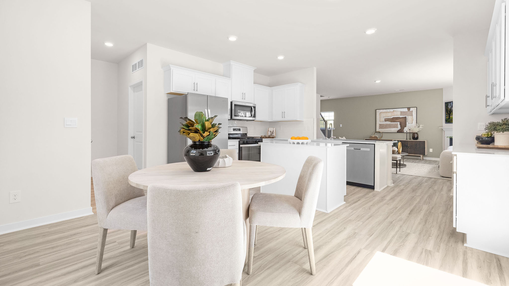 Kitchen and island with white cabinets