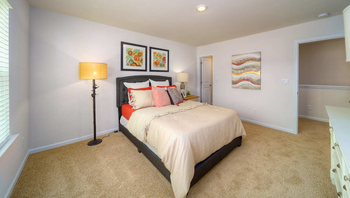 Carpeted bedroom with large window