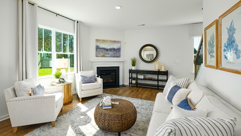 Open family room with fire place, vinyl floors, and large window