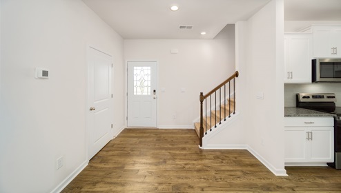 Welcoming foyer with view of front door and stairs