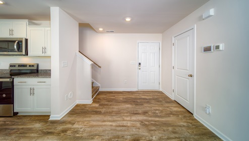 Welcoming foyer with view of front door and stairs