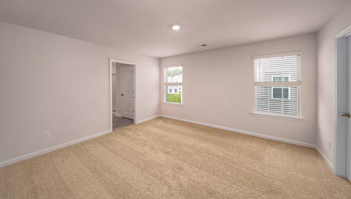 Primary bedroom, carpeted with large windows