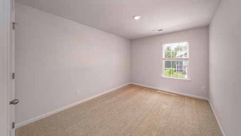 Carpeted bedroom with window