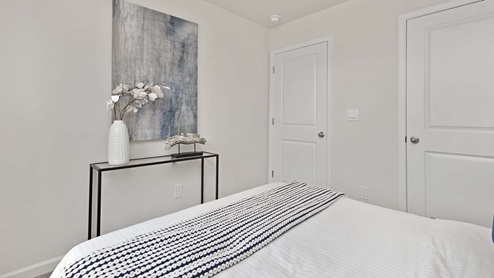 Carpeted bedroom with small window