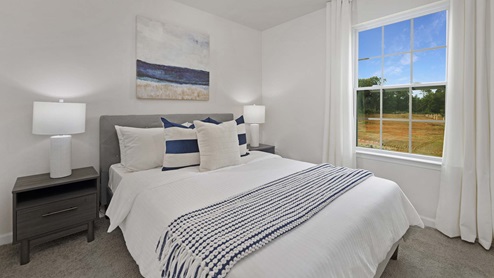 Carpeted bedroom with small window