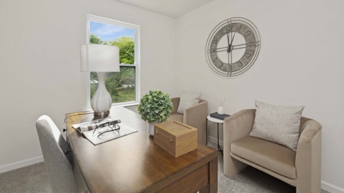 Carpeted bedroom with small window being used as an office