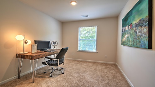 Carpeted bedroom, or study space, with large window