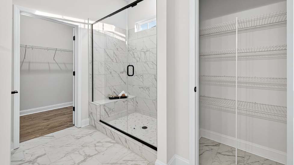 Primary bathroom with double sink  vanity and large walk in shower