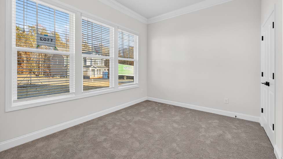 Carpeted bedroom with large window