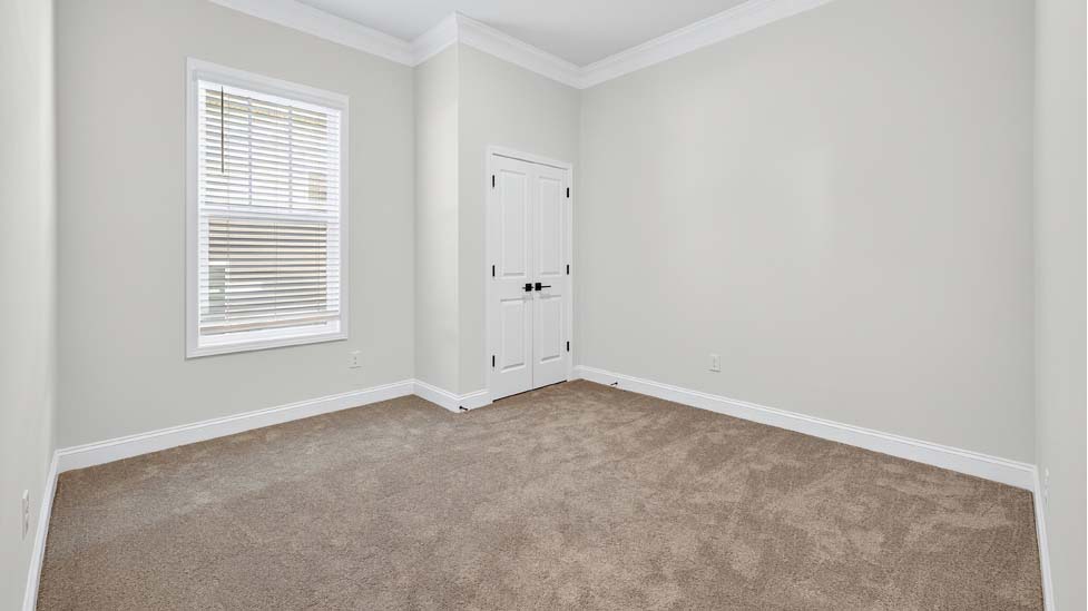 Carpeted bedroom with large window