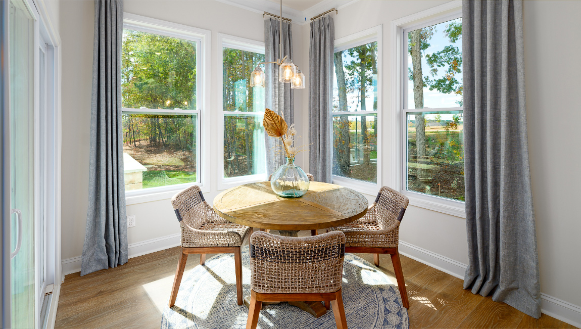 Breakfast area with wood floors, and surrounded by large windows