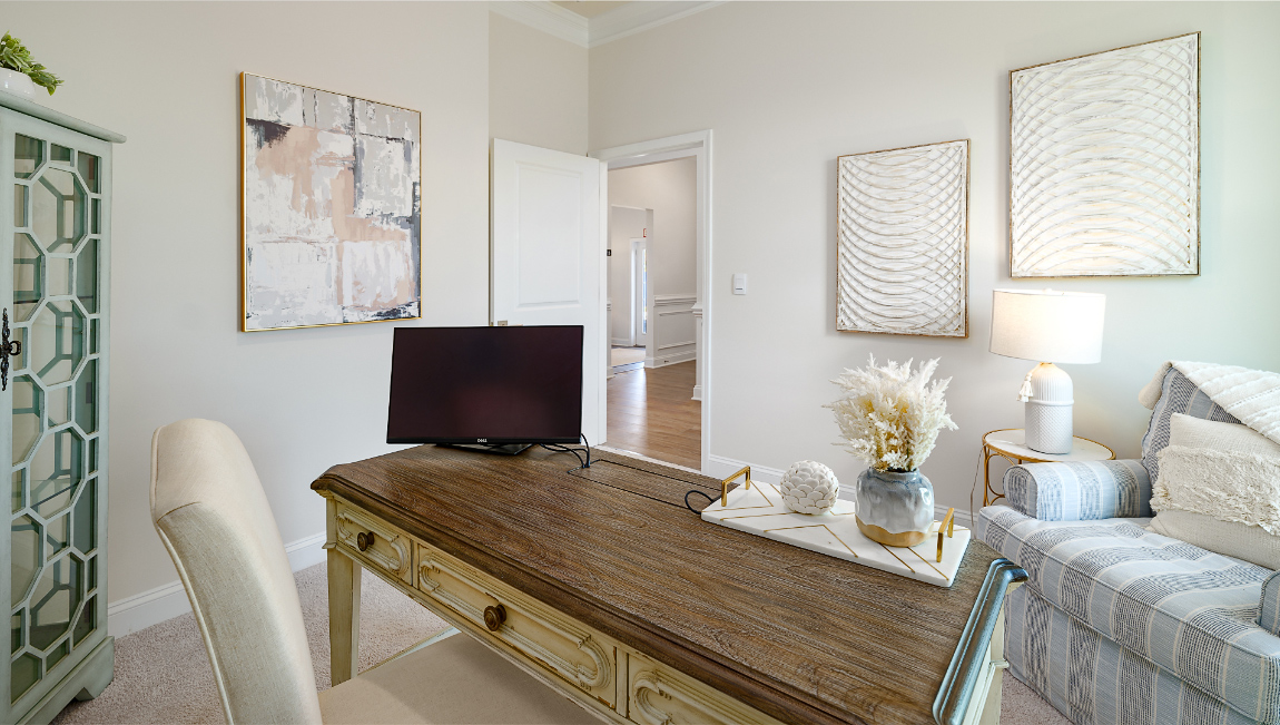 Carpeted bedroom with large window, being used as an office