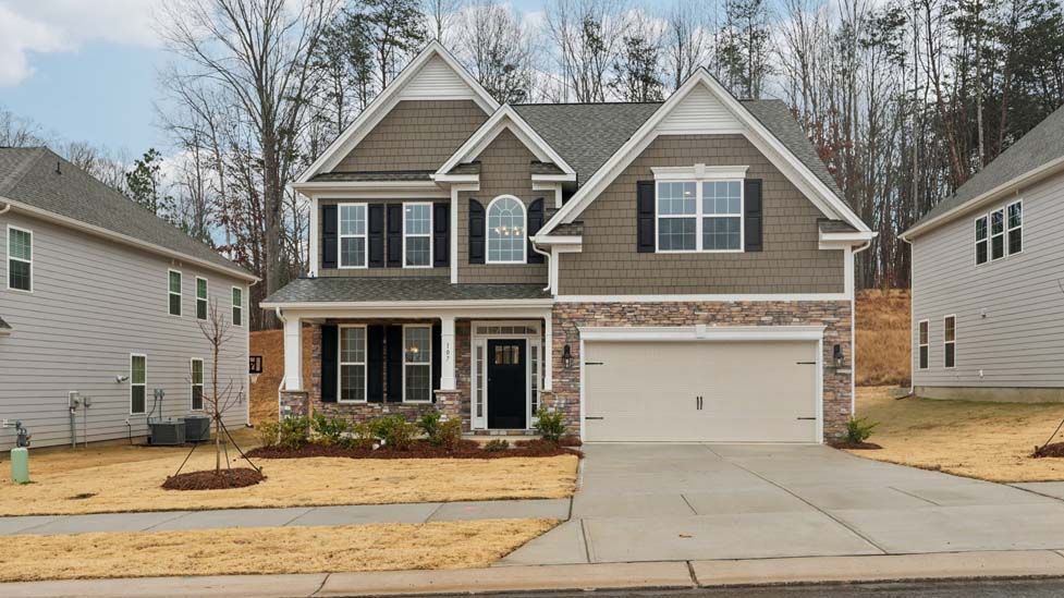 Fleetwood front exterior with brick and siding and two car garage