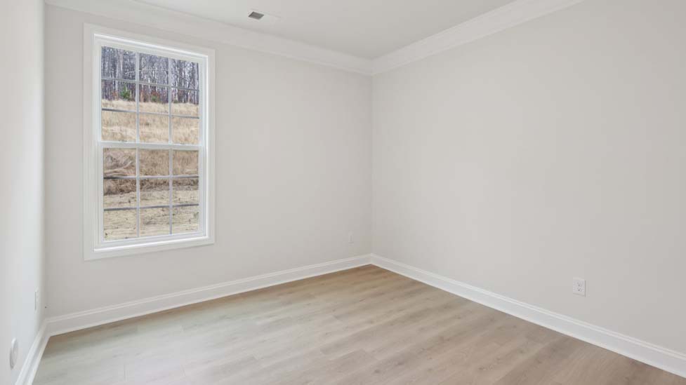 Carpeted bedroom with large windows