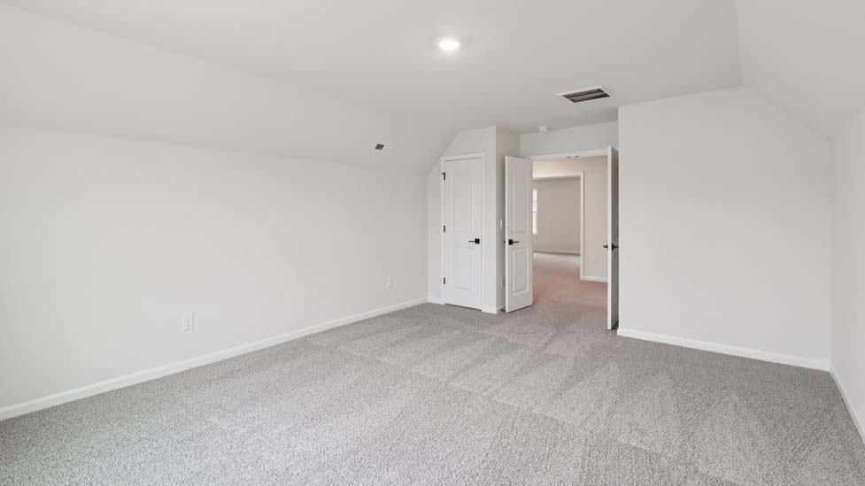Carpeted bedroom with large windows