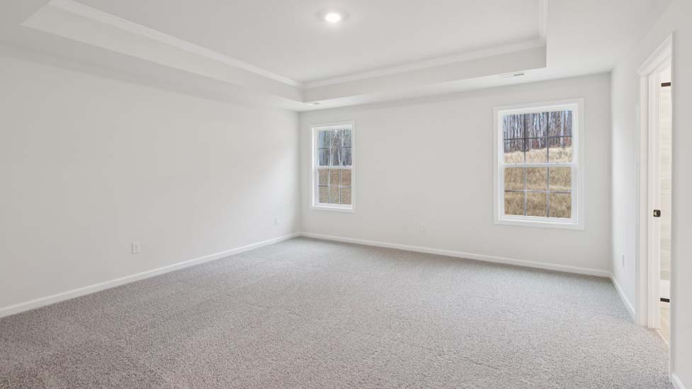 Carpeted bedroom with large windows