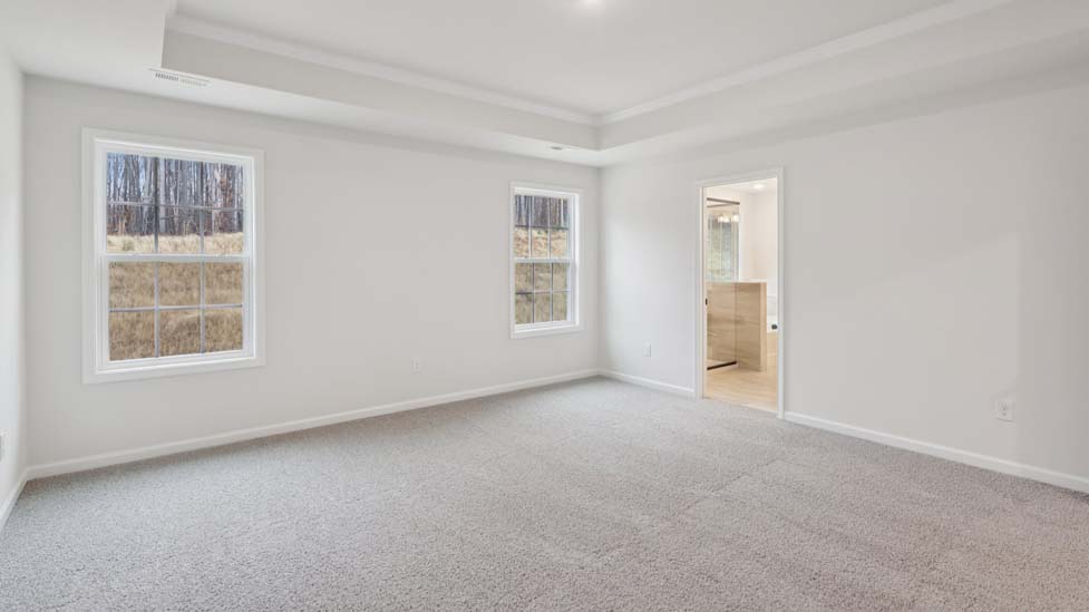 Carpeted bedroom with large windows