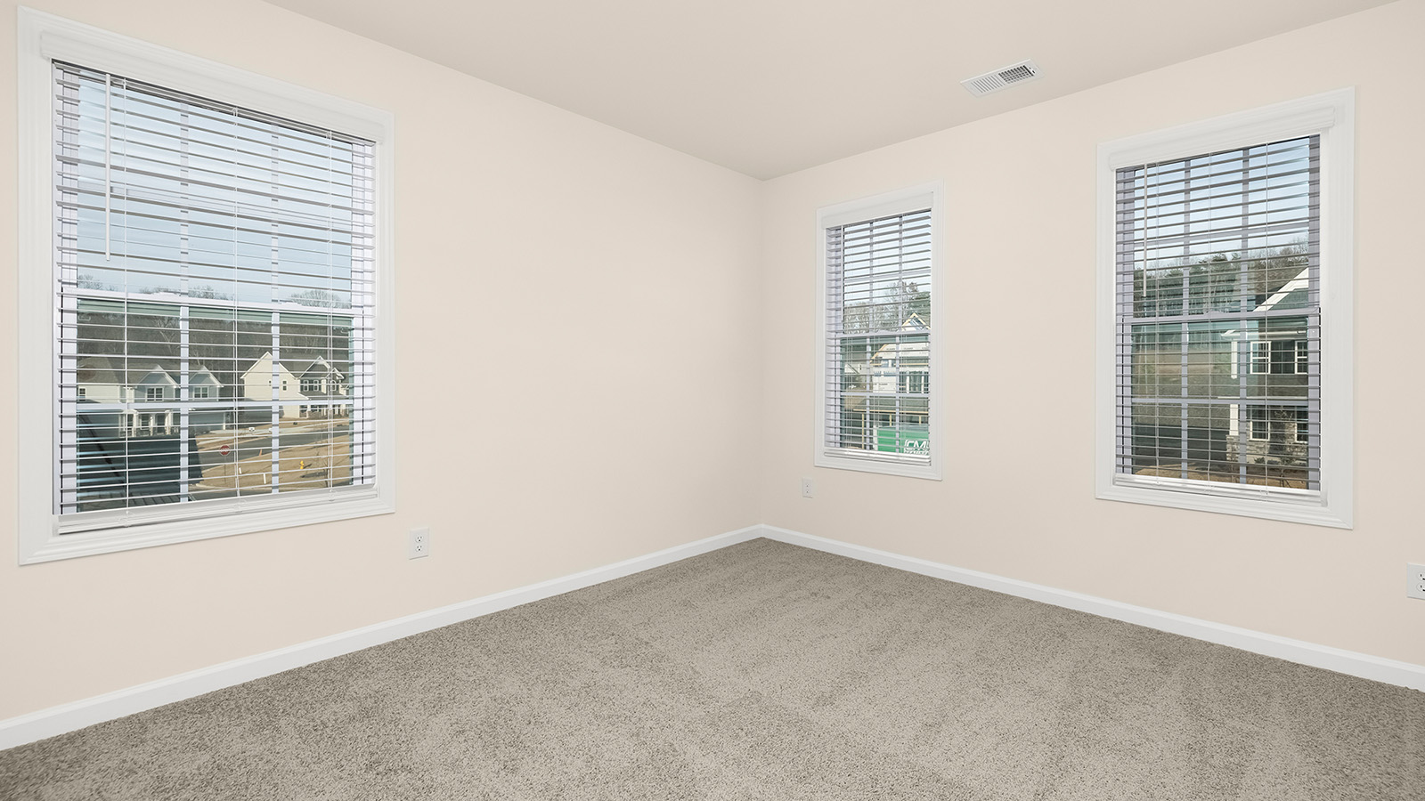 Carpeted bedroom with large windows