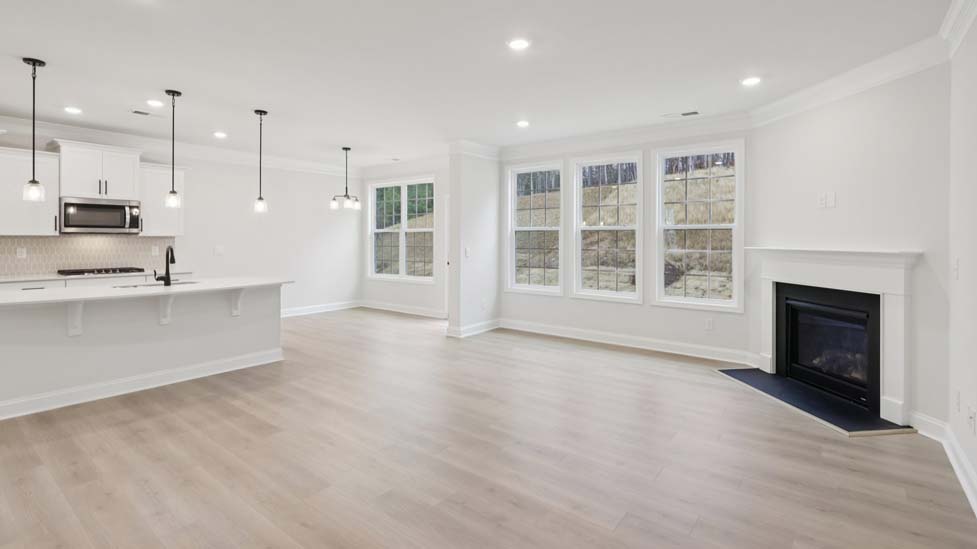 Open concept family room with fireplace and large windows