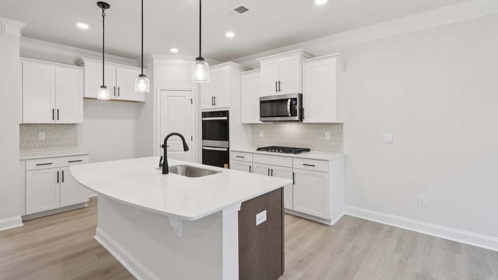 Kitchen and island with stainless steel appliances