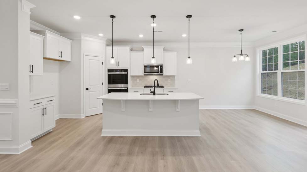 Kitchen and island with stainless steel appliances