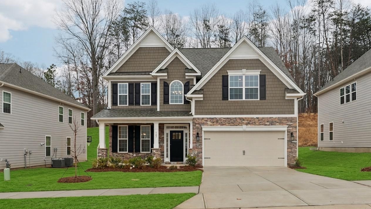 Fleetwood front exterior with brick and siding and two car garage