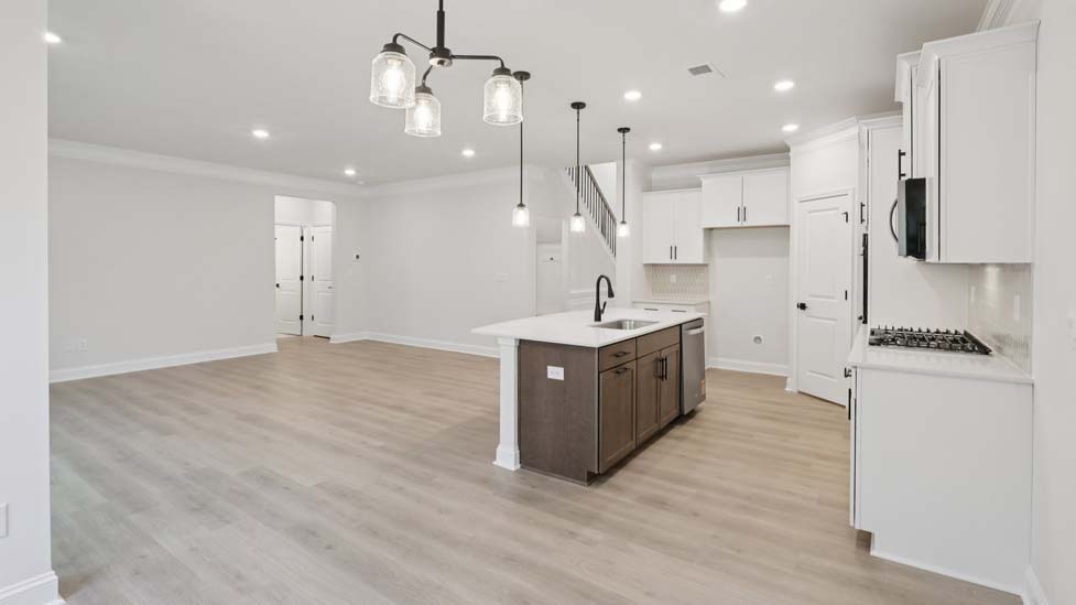 Kitchen and island with stainless steel appliances